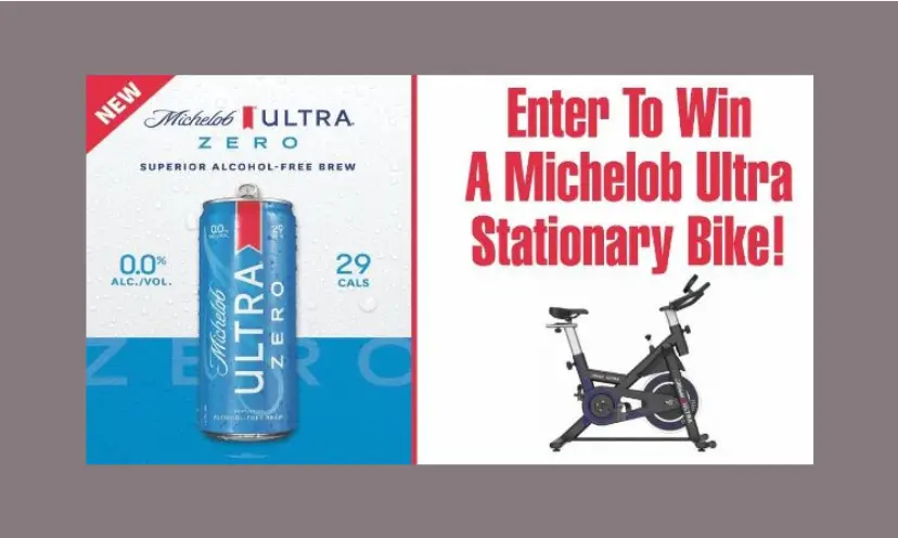 This predominantly red, white and blue photo features a can of Michelob Ultra beside the stationary bike that one winner will receive. The red lettering says "enter to win a Michelob Ultra stationary bike!"