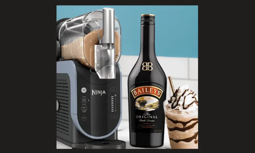 This photo features the Ninja SLUSHi maker with a bottle of Baileys Irish Creme and a delicious looking frozen drink with whipped cream and chocolate swirls!