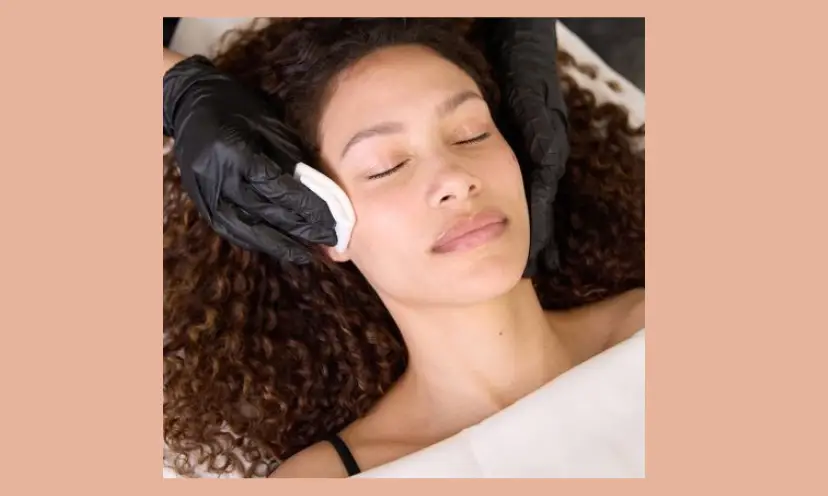 This is a photo of a young woman, eyes closed and relaxing as she is receiving a professional facial skin care treatment.