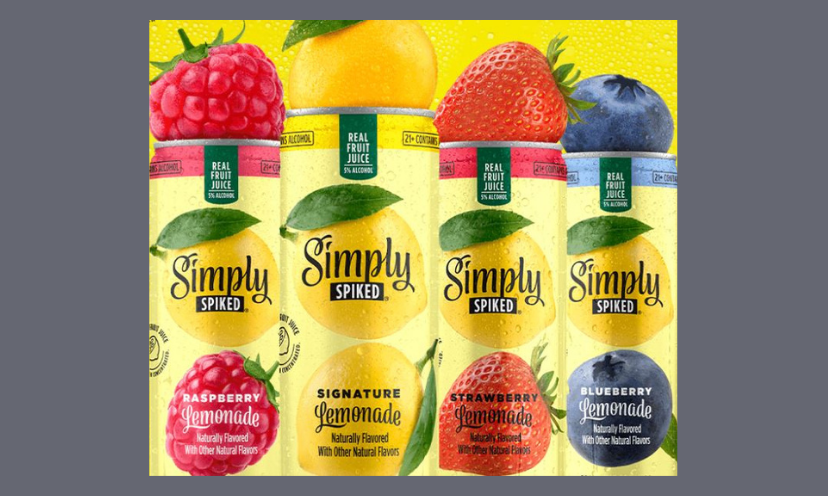 Simply Spiked is a part of this giveaway and this photo features four cans of the beverage, topped with the fruit that flavors it. Those sweet delicacies are a raspberry, lemon, strawberry and a blueberry!