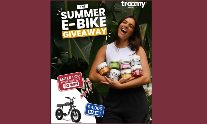 This photo features a lovely young lady holding an armload haul of the Troomy supplements. There is an addition of the ebike in the bottom corner and the caption says "The Summer E-Bike Giveaway...$4,000 value"!