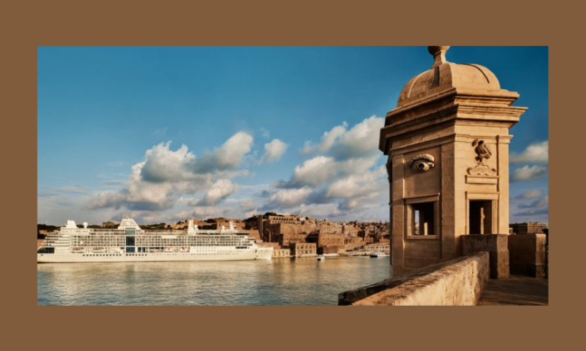 This is a photo of a cruise ship surrounded by beautiful Mediterranean buildings, water and views!