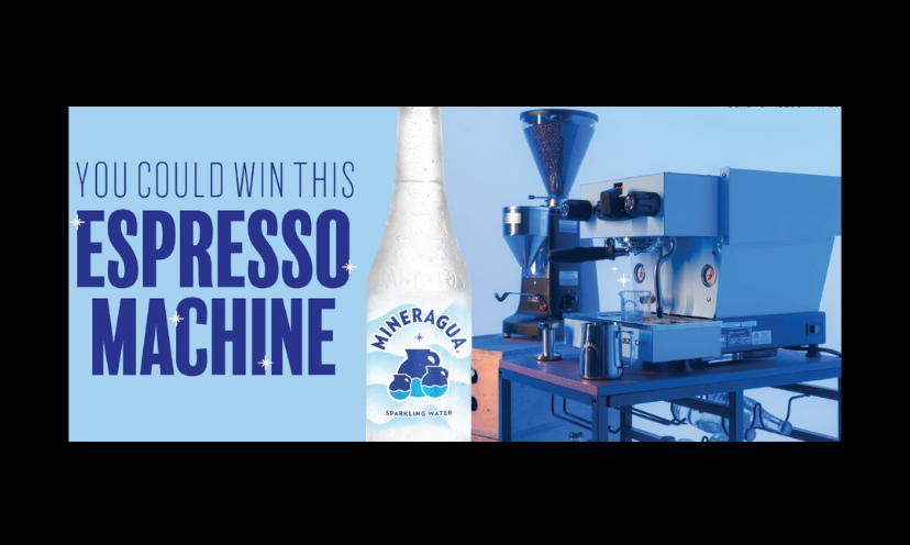 This is a photo of the $5,999 espresso machine in this giveaway. It is sitting beside a bottle of Mineragua sparkling water. (which is one of the prize sponsors) The text says :"You Could Win This Espresso Machine"!