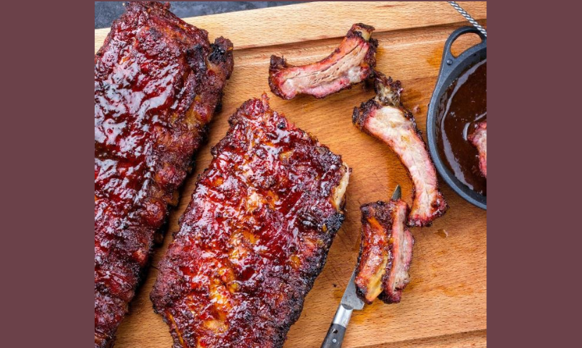 This photo is almost indescribable as it features two amazing and delicious racks of ribs...cooked to perfection with a luscious sauce on the side!