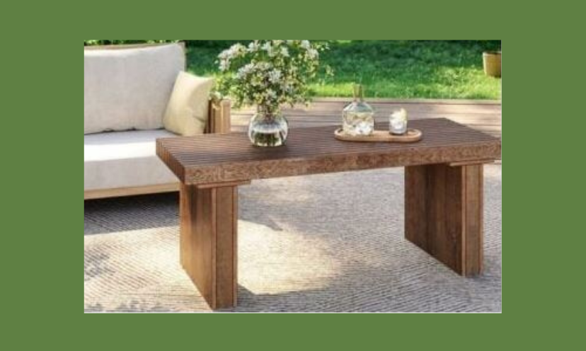 This is an upclose picture of the coffee table offered in this sweepstakes. It is topped with drinks and a beautiful vase of green and white flowers.