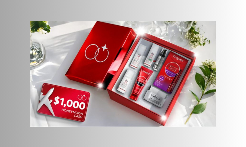 This photo shows the bright red and impressive beauty boxes beside a $1,000 gift card. Both are displayed on a wedding ready table with white flowers to the side!