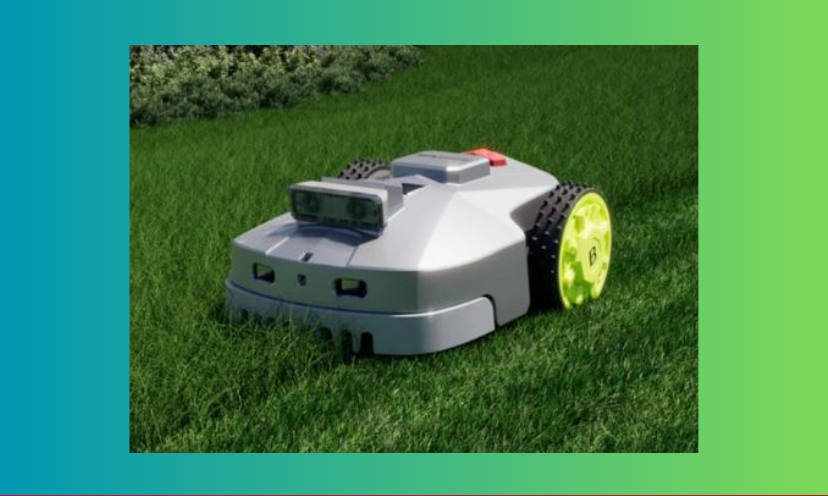 This is a close up photo of the Titan Robot Lawn Mower sitting on incredibly lush, green grass.
