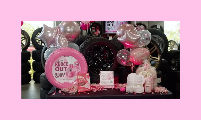 This photo is loaded with tires, balloons and spa themed items. One tire is pink in recognition of breast cancer awareness, and inside that tire is the caption "help us knock out breast cancer"!