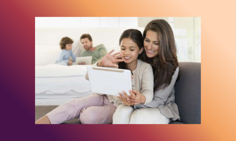 This is a photo of a mom and daughter scoping out giveaways on the moms laptop...and dad and son doing the same in the background!