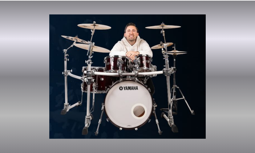 This photo contains the drum set available in this giveaway...with an added drummer ready to play and share the beat!