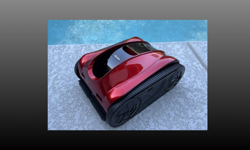 This is a photo featuring a lone shot of the pool cleaner you could take home in this giveaway. It is sitting poolside waiting to get the job done!