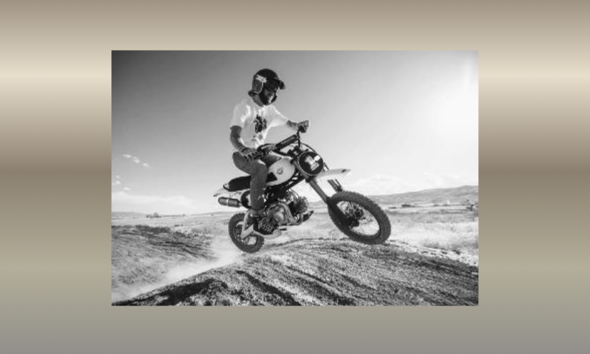 This is a black and white photo of a fellow riding up an incline on his powerful 805 Buscadero pit bike...like the one in this exciting giveaway!