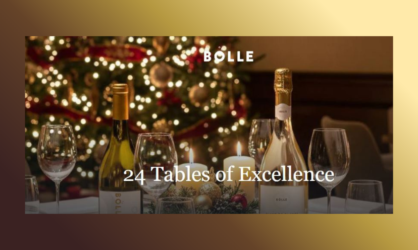 This photo features a five star table at a restaraunt of the same. It includes wine bottles, wine glasses and an exquisite Christmas tree in the background! The caption says "24 Tables of Excellence"!