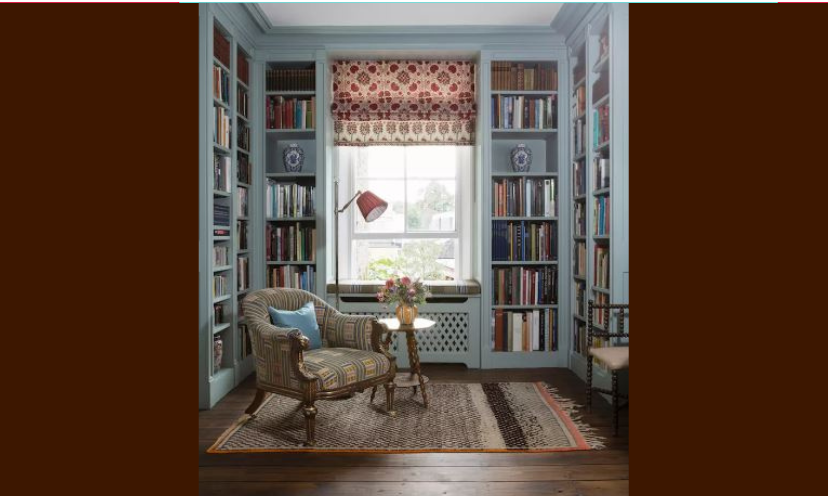 This photo is an inspiration as to what a cozy reading nook or at home library could look like. The wall to wall shelving holds the books and window seat, chair, warm wood flooring and table add to the comfort!