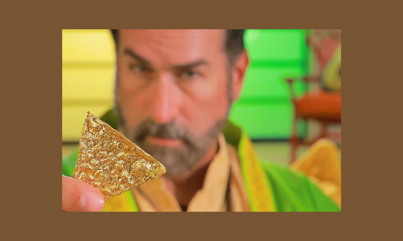This is a photo of a bearded man holding a shiny and highly valuable 14 karat gold tortilla chip. You could win one of your own in this stand out giveaway!