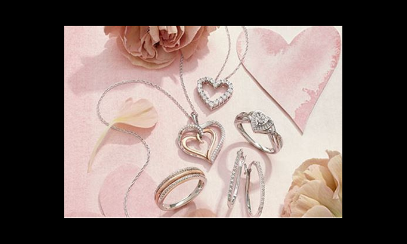 This photo is loaded with Valentine themed diamond jewelry positioned among heart shaped cut outs and pink flowers!