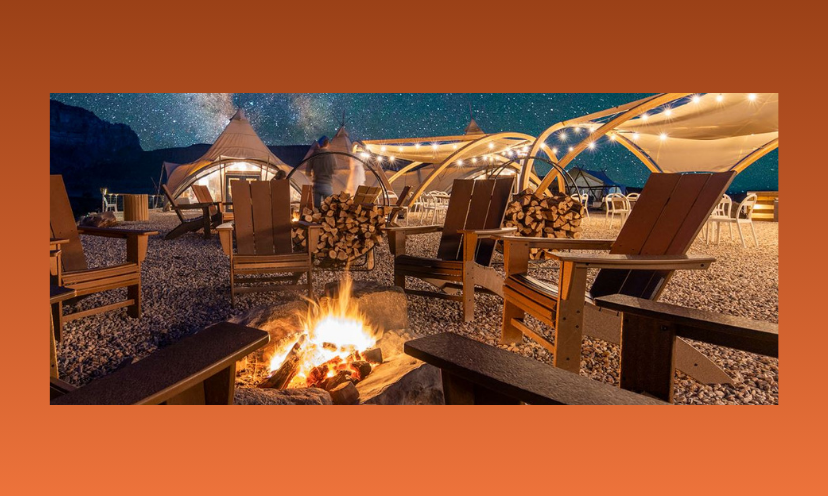 This photo is a cozy glamping setting complete with chairs surrounding a blazing fire pit against a sky with thousands of stars. In the background is an upscale tent made for the glamping life!