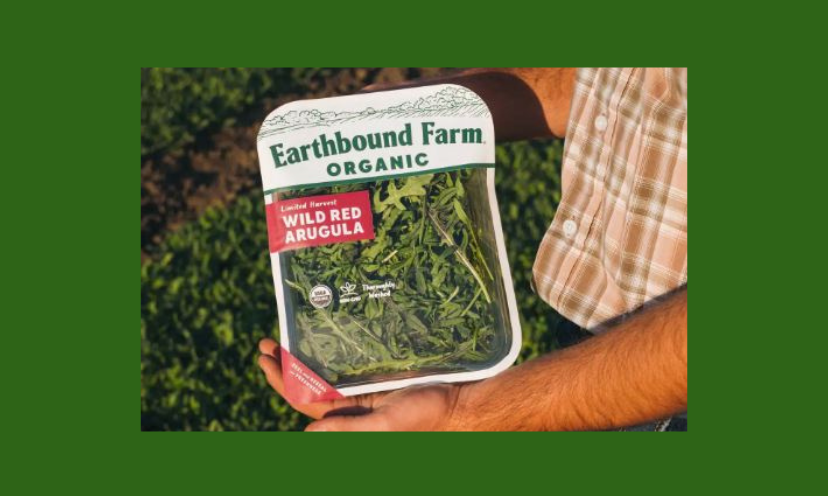 This photo features a man, maybe a farmer, holding a package of Earthbound organic greens with more crops in the background. Enter to win a year's' worth of healthy eating worth over $800!