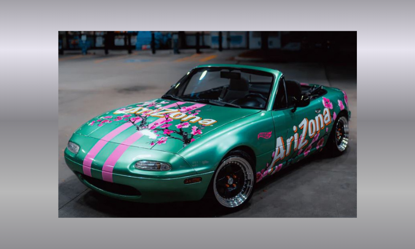 This is a photo of the 1990 Mazda Miata Roadster vehicle wrapped in an AriZona Green Tea Blossom design valued at $10,000...and you could win int in this giveaway!